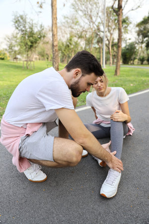Full length shot of young girl fall down because of the dizziness from too much exercise and young...