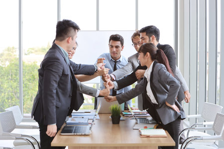 success business deal with stacking hands of business people (teamwork or partnership concept)
