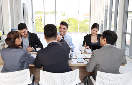 Multiethnic business people discussing company about new project in meeting room then they shaking...