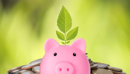 Business investment and saving growth for advertising concept. Plant growing on piggy bank on...