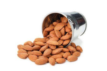 Close up group of stainless cup filled with peeled almonds nuts on white background isolated for your advertisingの写真素材