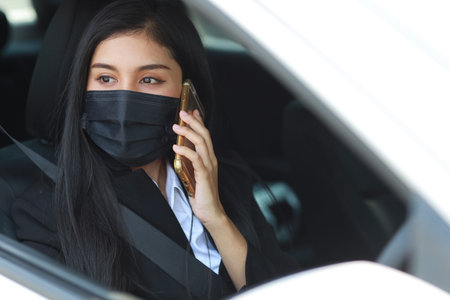 Young asian healthy woman in business black suit with protect mask for healthcare in automobile and...