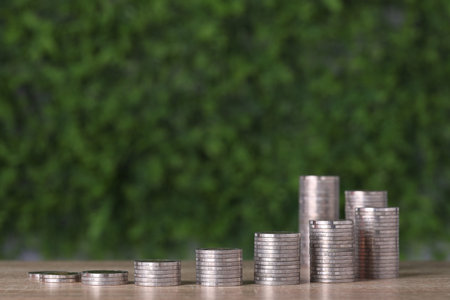 Business investment and saving growth for advertising concept. Stacking coin growing on wood table...