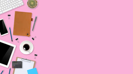 flat lay workspace table with laptop computer, office supplies, coffee cup, tablet and cell phone on pink pastel backgroundの写真素材