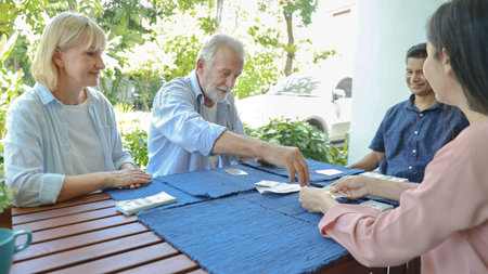 a group of multiethnic senior people playing chess board with happy smiling face on sunny day