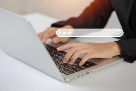 Attractive female hands using laptop computer searching, browsing internet data online information with search bar console interactive on screen. Lifestyle with technologyの写真素材