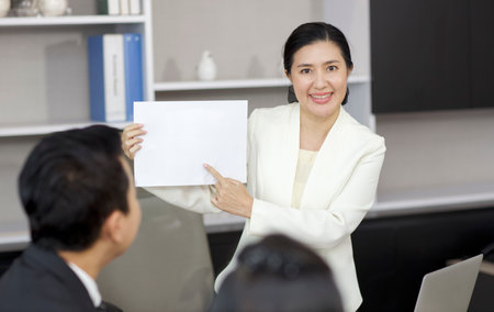 Collaborative process of professional businesspeople going over on new project, using paperwork and computer presentation with brainstorming ideas, coworker and work together at office meeting conceptの写真素材