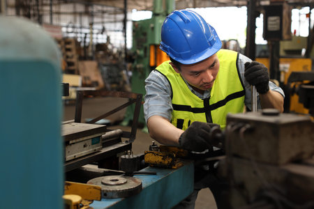 Technician engineer or worker in protective uniform standing and repairing operation or checking...