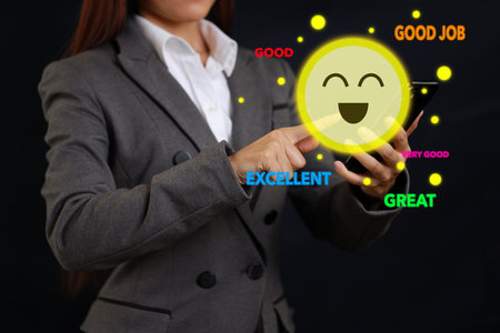Smart customer woman hands pressing on online application screen with excellent 5.0 rating for service evaluation on smartphone virtual touch screen. Customer satisfaction survey experience concept.の写真素材