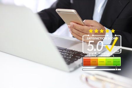 Smart customer man hands pressing on online application screen with excellent 5.0 rating for service evaluation on smartphone virtual touch screen. Customer satisfaction survey experience concept.の写真素材