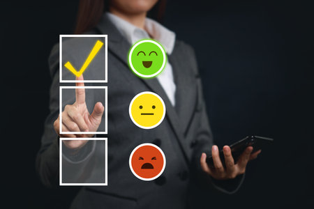Smart customer woman hands pressing on online application screen with excellent 5.0 rating for service evaluation on smartphone virtual touch screen. Customer satisfaction survey experience concept.の写真素材