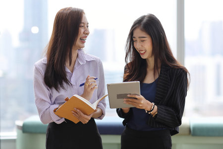 Collaborative process of young asian business people team working together discussing, researching,...
