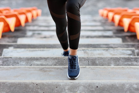 Close up strong and beautiful fitness female sportswoman legs morning run and workout at stadiumの写真素材