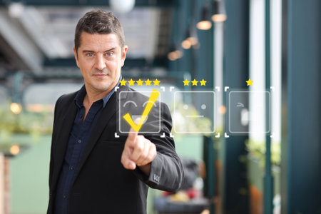 Happy caucasian customer man pressing on online application with excellent rating for service evaluation on smartphone virtual touch screen. Customer satisfied survey experience conceptの写真素材