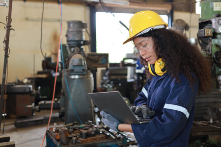 Technician engineer woman in protective uniform working with computer while maintenance operation or...