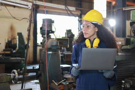 Technician engineer woman in protective uniform working with computer while maintenance operation or...