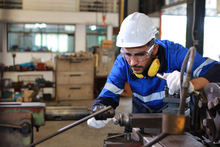 Technician engineer or worker man in protective uniform with safety hardhat maintenance operation or...