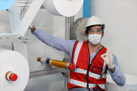 Caucasian mechanic technician maintenance, repairing industrial machinery equipment in factory....