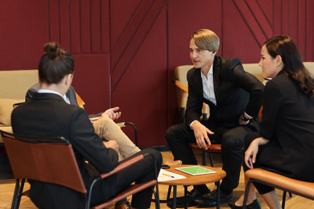 Collaborative process of multiethnic business people team working together discussing, researching, brainstorming and planning work at business meeting workplace in modern office buildingの写真素材