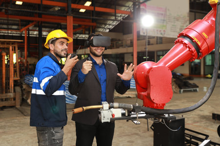 Professional heavy industry technician engineer with workwear and businessman maintenance and check part of robot arm machine with VR virtual in factory automotive. Industrial and technology conceptの写真素材