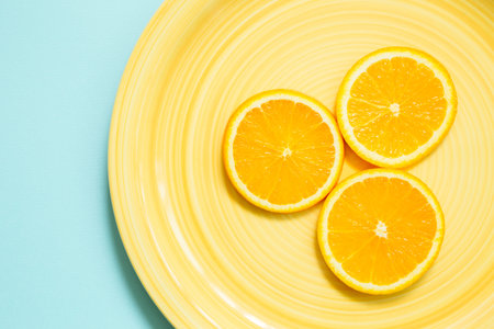 fresh orange on yellow plate