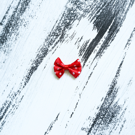 Red ribbon on white paint backgroundの写真素材