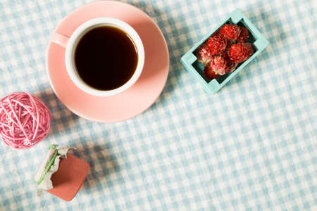 Coffee and ornaments on check pattern fabric backgroundの写真素材
