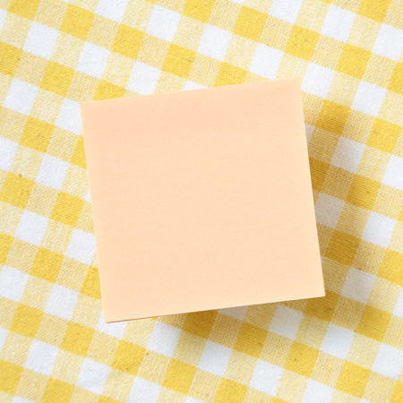 Reminder sticky notes on yellow check pattern fabric backgroundの写真素材