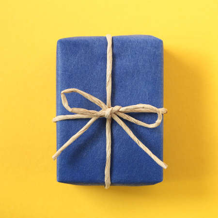 Blue color gift box on yellow backgroundの写真素材