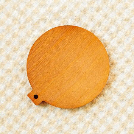 Blank wooden coaster on check pattern fabric backgroundの写真素材