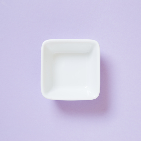 White dish isolated on purple backgroundの写真素材