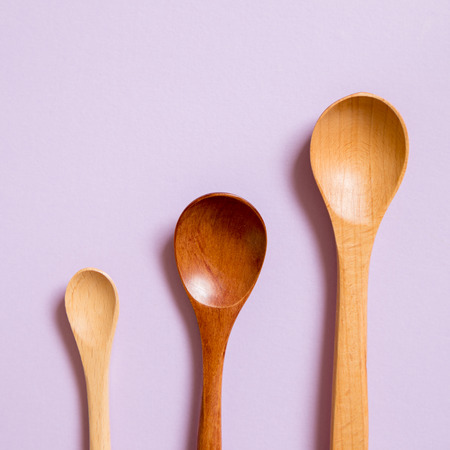 Wooden spoons on purple backgroundの写真素材
