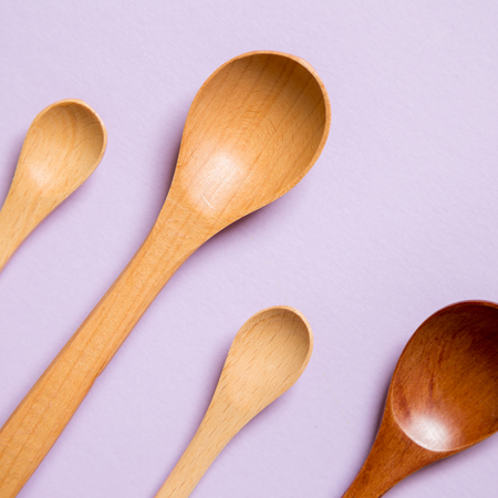 Wooden spoons on purple backgroundの写真素材