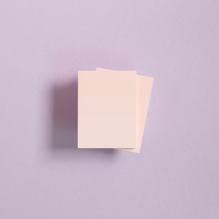 Pink memo pad, sticky notes on purple backgroundの写真素材