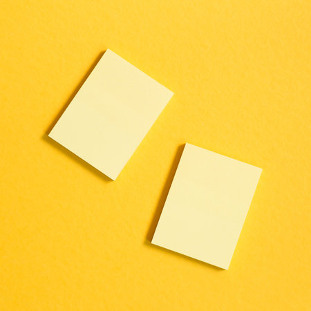 Yellow memo pad, sticky notes on yellow background