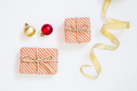 Christmas concept. Gift box and curling ribbon and bauble on white backgroundの写真素材