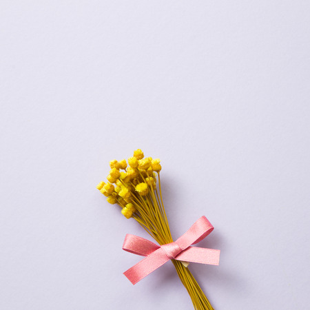 Yellow dry flower bouquet on purple backgroundの写真素材