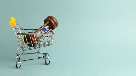 Hourglass in a shopping cart. Buying time concept, time is moneyの写真素材