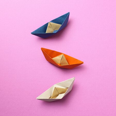 Paper ship on pink backgroundの写真素材