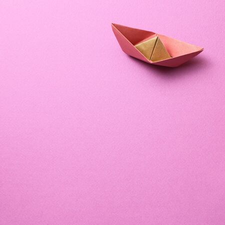 Paper ship on pink backgroundの写真素材