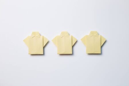 Yellow paper shirt origami on white backgroundの写真素材