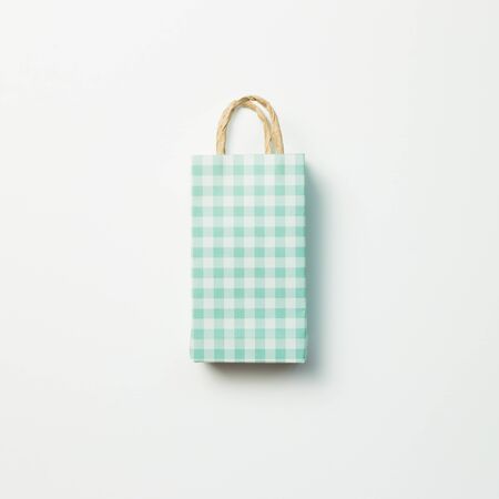 Green paper shopping bag on white backgroundの写真素材