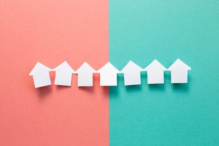 Paper house model on pink green background. Real estate concept
