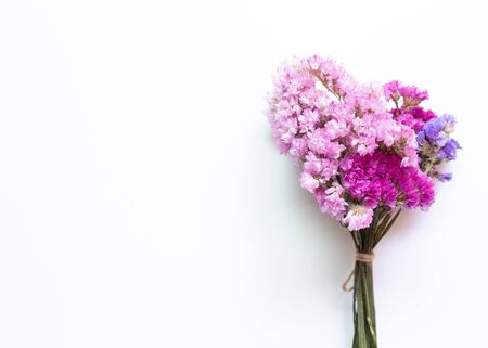 Pink purple statice flowers bouquet on white background. Floral composition, flat lay, top viewの写真素材