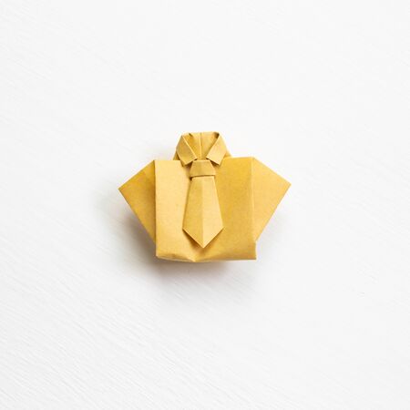 Yellow paper shirt origami on white backgroundの写真素材