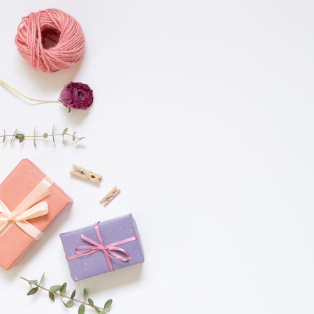 Gift boxes with wrapping tools on white background. top view, copy space
