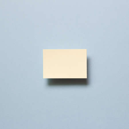 Yellow memo paper, sticky notes on blue background. top view, copy spaceの写真素材