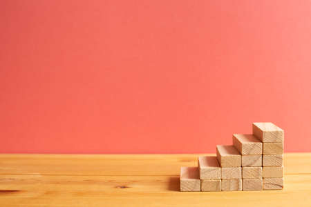 Wood block stairs with pink background. Business development, growth, success concept. with copy spaceの写真素材