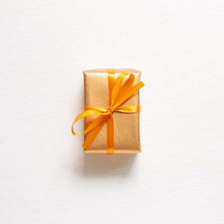 Gold gift box isolated on white background. top view