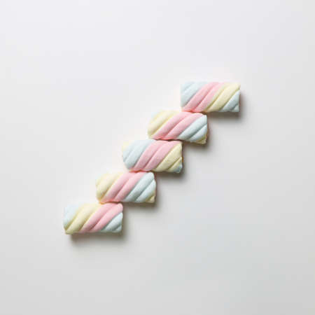 Stairs. Colorful marshmallow on white background. flat lay, top viewの写真素材